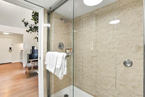 a bathroom with a shower with a glass door at Carmel Resort Inn in Carmel