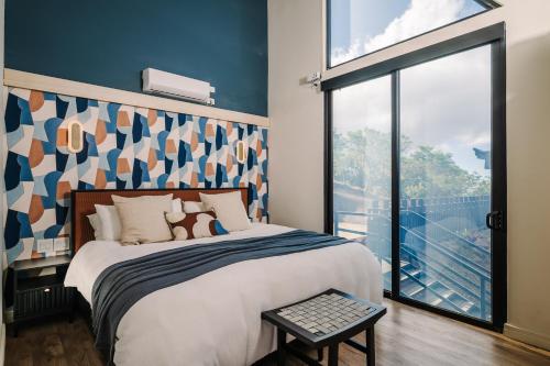 a bedroom with a bed and a large window at Lakay Monteverde with Heated Pool, Golf Cart, Breakfast in Monteverde Costa Rica