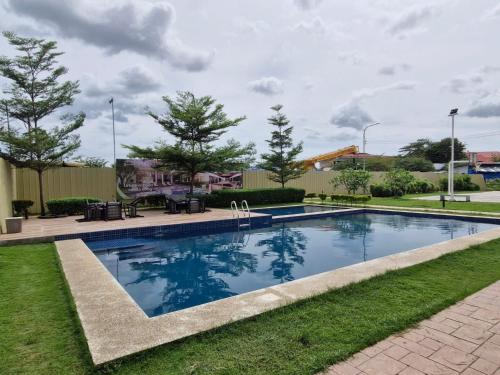 a swimming pool in a yard with grass and trees at Yangs Homeey Place2 in Bankal
