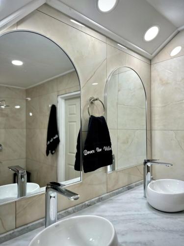 a bathroom with two sinks and a large mirror at Dover View Villas in Carriacou