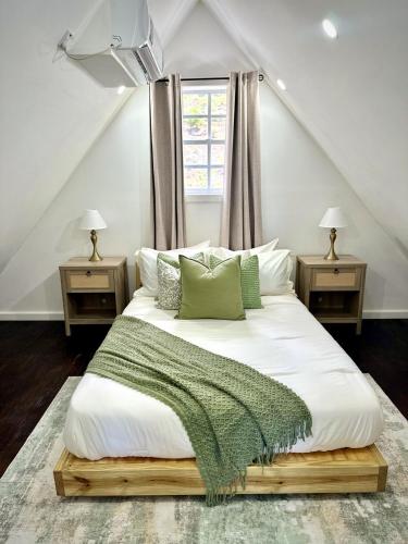 a bedroom with a large white bed with two night stands at Dover View Villas in Carriacou