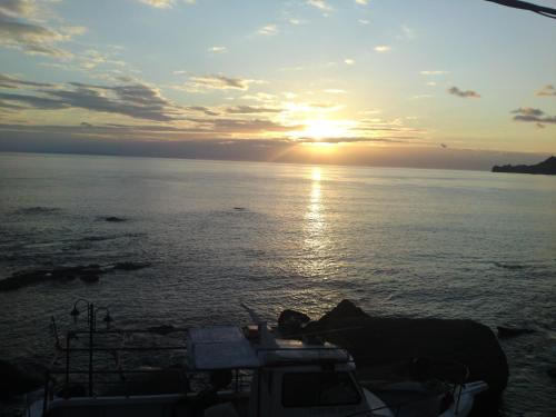 a sunset on a boat in the water at Atlantis in Plakias