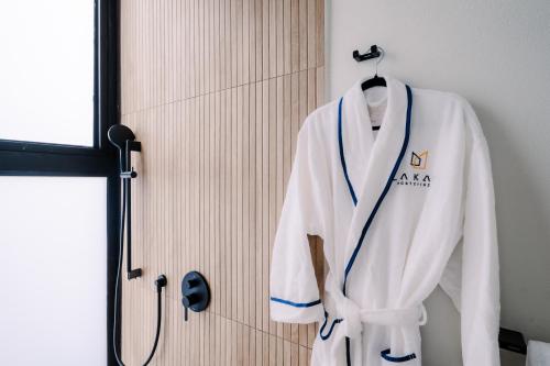a white robe is hanging on a door at Lakay Monteverde with Heated Pool, Golf Cart, Breakfast in Monteverde Costa Rica