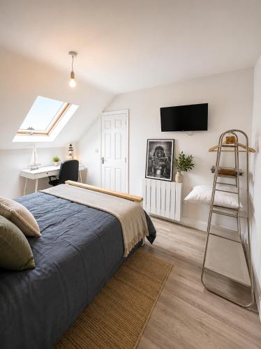 a bedroom with a bed and a ladder and a desk at Charlettes Lodge in Cobh