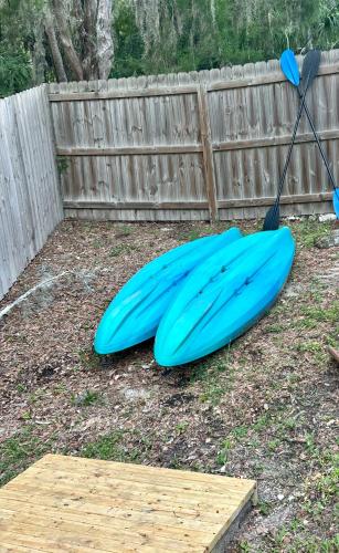 a pair of kayaks sitting on the ground next to a fence at Natures Nest #2 in Homosassa