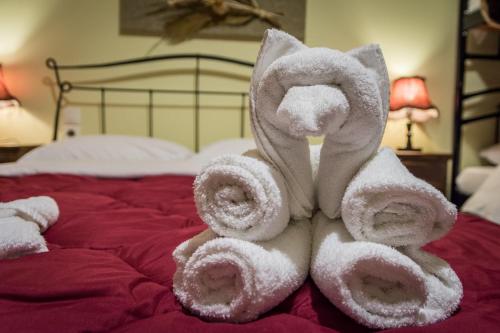 a towel animal sitting on top of a bed at Xenonas Sta Tzakia in Karpenisi