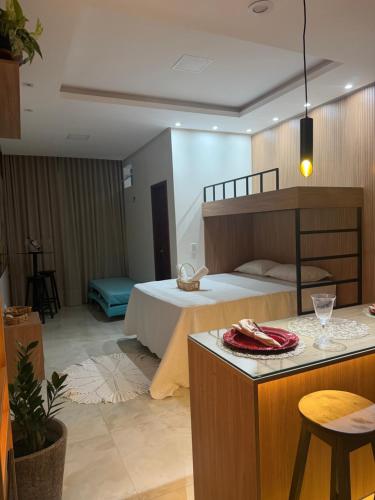 a bedroom with a bed and a bar with a table at Ilha Bela Flat Alter do Chão in Santarém