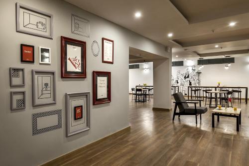 a room with a wall with pictures on it at Townhouse Hotel Spotlight in Nawābganj