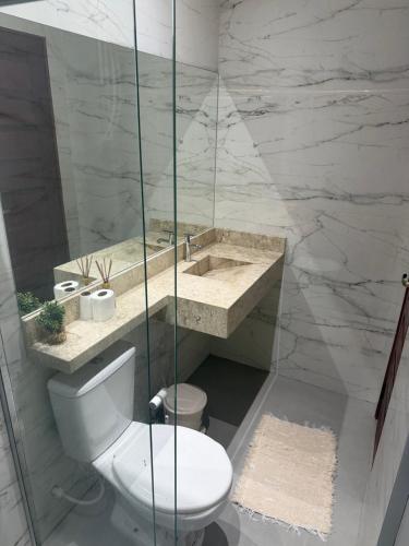 a bathroom with a toilet and a sink at Ilha Bela Flat Alter do Chão in Santarém