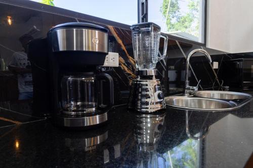 a blender sitting on a counter next to a sink at Fernando's Bungalow in Puerto Ayora