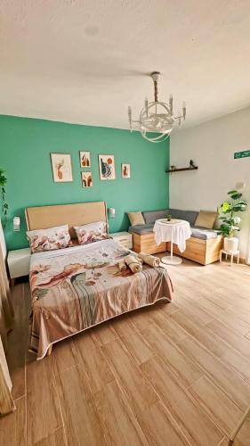 a large bedroom with a bed and a couch at Rooftop Treehouse - Hammam Sousse in Sousse