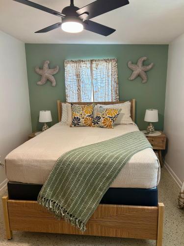 a bedroom with a bed with a ceiling fan at Natures Nest #2 in Homosassa