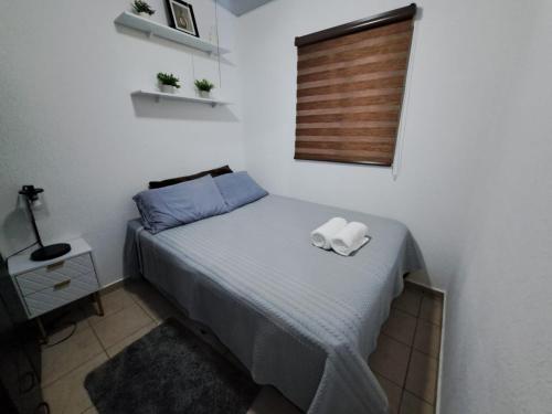 a bedroom with a bed with two towels on it at The terrazzo house in Santa Ana