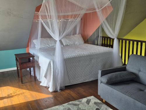 a bedroom with a white bed with a canopy at Southern Sunset Villa in Choiseul