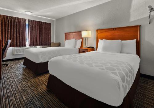 a hotel room with two beds and a window at Park Inn by Radisson, Detroit Metro Airport in Romulus