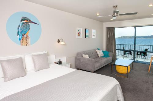 a bedroom with a king sized bed with a bird on the wall at Boulevard Waters in Taupo