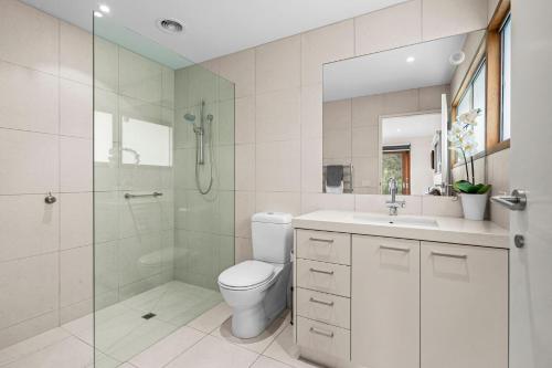 a bathroom with a toilet and a shower and a sink at 9 Doors From Front Beach in Point Lonsdale