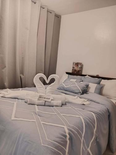 a bedroom with a bed with a heart on it at California style Resident in Iloilo City