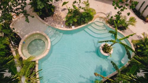 an overhead view of a swimming pool in a resort at Casa Wayra Tulum - Boutique Condos in Tulum