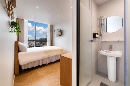 a hotel room with a bed and a sink at Stay5 Jongno in Seoul
