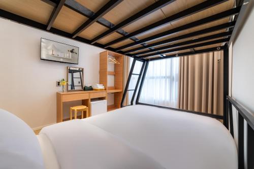 a bedroom with a white bed and a window at Stay5 Jongno in Seoul