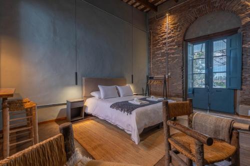 a bedroom with a bed with a blue door at La Piamonte 1903 in Azcuénaga