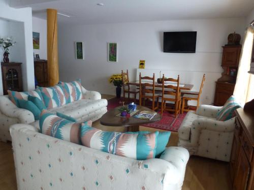 a living room with two couches and a table at Little Black Bear Lodge/B&B in Bridge Lake