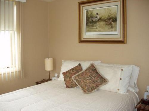 a bedroom with a white bed with two pillows at Summit View Lodge in Seward