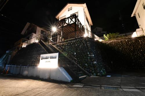 a set of stairs with a sign on it at night at BLUEBAY TERRACE okutama in Okutama