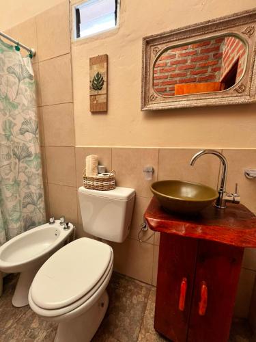 a bathroom with a white toilet and a sink at Departamento Ayllu IV in Tilcara