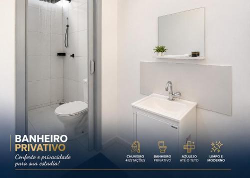 a white bathroom with a toilet and a sink at Apartamento nº 5 - Pousada Itapetininga in Itapetininga
