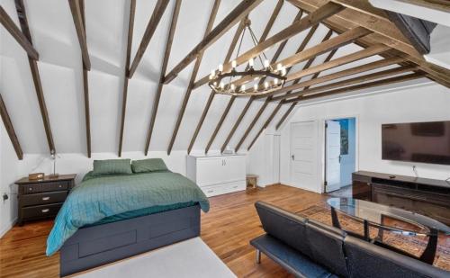 a bedroom with a bed and a glass table at Studio Apartment in Smithtown