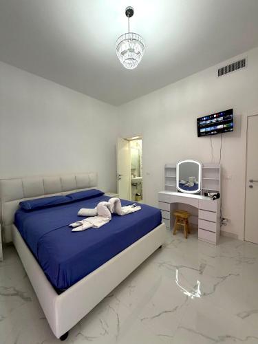 a bedroom with a bed and a desk and a television at Perla Azzurra in Savona