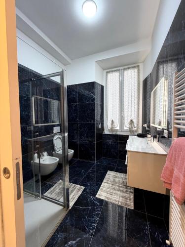 a bathroom with a toilet and a sink and a shower at Perla Azzurra in Savona