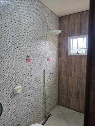 a bathroom with a shower with a glass door at Pousada Dubai in Cuiabá