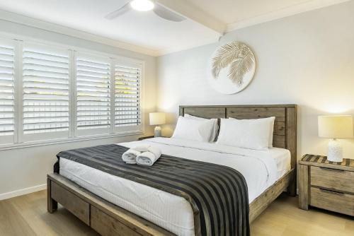 a bedroom with a large bed with two towels on it at Apartment 4B in Lennox Head