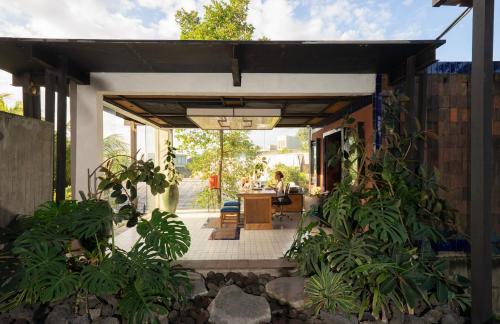 a covered patio with a table and chairs at Shore Amora Canggu in Canggu