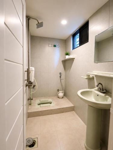 a small bathroom with a sink and a shower at Mall Rd Murree Ciros Hotel in Murree