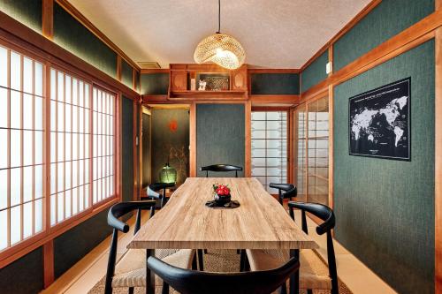 a dining room with a wooden table and chairs at Nikko Botan - 3 Min Walk from JR Nikko Station in Nikko