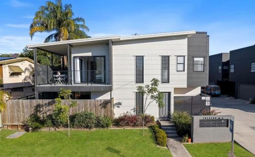 a house with a fence and a yard at Gemstone in Morayfield