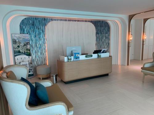 a lobby with a reception desk in a room at The Title Serenity Naiyang in Ban Bo Han