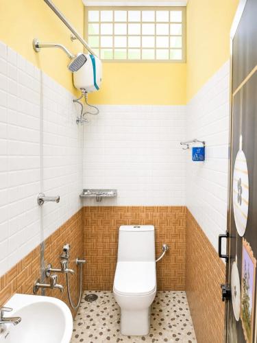 a bathroom with a toilet and a sink at DilsBreak HomeStay in Kanyakumari