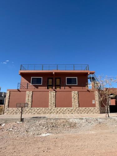 a house on the side of a dirt road at Apart Mirador del Valle in Cachí