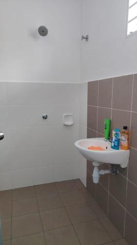 a bathroom with a white sink in a room at Cahaya 382 in Sitiawan
