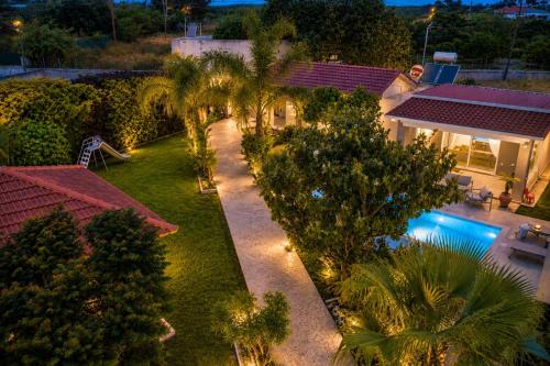 an aerial view of a house with a swimming pool at Sea Breeze & Nature villa, with heated pool and garden retreat in Kremasti