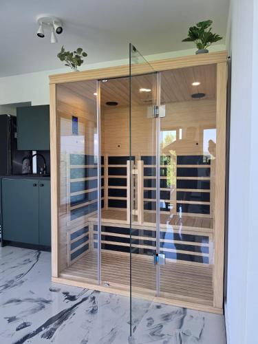 a bathroom with a glass shower in a room at Luni Stay - Jacuzzi, Sauna & Nature Escape in Jastrebarsko