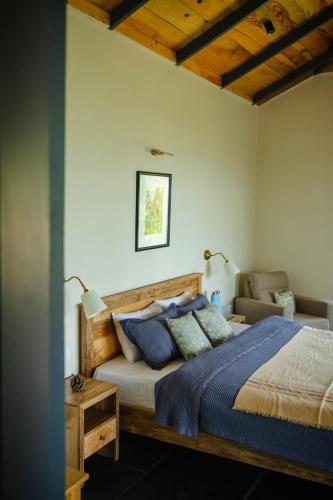a bedroom with a wooden bed and a couch at The Chitai Life in Almora