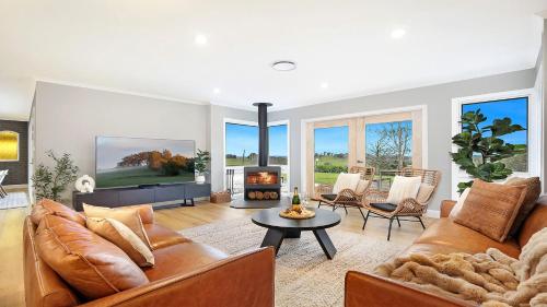 a living room with a couch and a fireplace at Curra Nardie Ranch in Sutton Forest