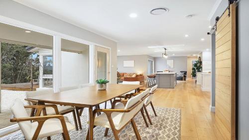 a dining room and living room with a table and chairs at Curra Nardie Ranch in Sutton Forest