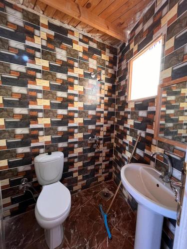 a bathroom with a toilet and a sink at ACACIA Camp in Nuweiba